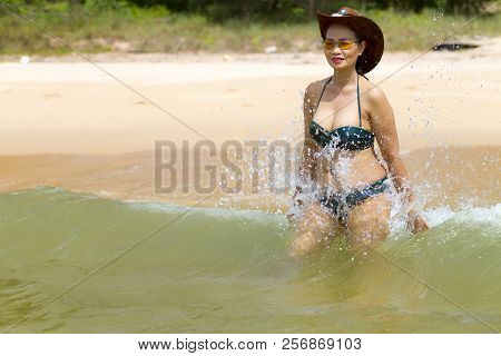 Woman Shape Beautiful Enjoy With Bikini Hat And Wave On Beach At Bang Beot Beach, Chumphon Province 