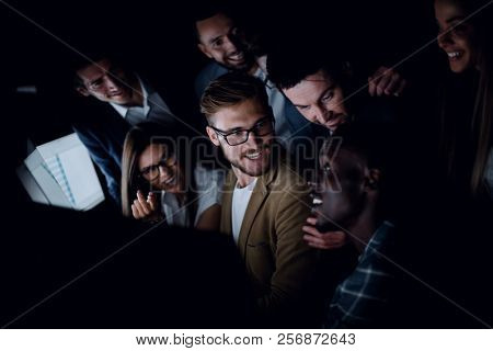 close up.successful business team sitting near the desktop in the evening