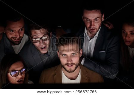 close up. the programmer and his colleagues are working late