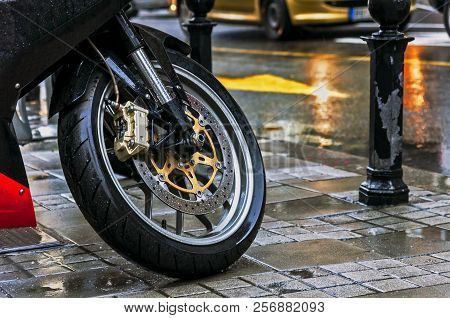 Large Motorcycle Leaning On Its Stand In The Rain In The City