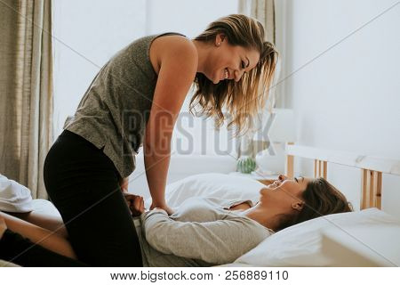 Lesbian couple having fun in bed