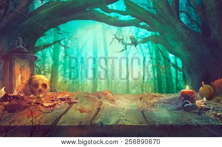 Halloween Theme With Pumpkins, Skull And Dark Forest. Scary Halloween Design On Table