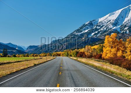 Highway in Colorado Rocky Mountains at autumn, USA. Mount Sopris landscape.