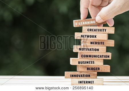 Blur Hand Placing Sign Wood With Graduation Celebrating Cap On Wooden Blocks Tower Space For Letter 
