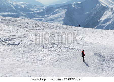 Snowboarder And Skiers Downhill On Snowy Off-piste Slope In Sun Winter Morning. Caucasus Mountains, 