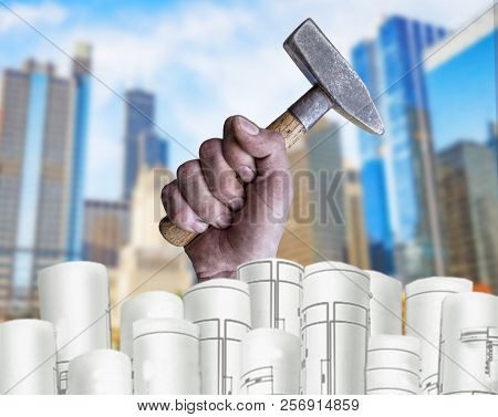 Hand Holding Pilers With Architect Plans And City Background