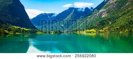 Norway Nordfjord Fjord Panoramic Banner With Glacier, Forest Mountains Landscape And Rural Houses. N