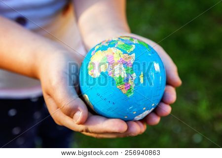 Earth Globe In Children Hands. Little Girl Holding Symbol World Map. Environment Conservation, Save 