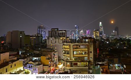 Ho Chi Minh City, Vietnam - January 2nd 2018. A Full Moon And The Saigon Skyline Looking Towards The