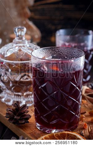 Scandinavian Hot Alcoholic Drink With Cinnamon In A Glass Cup On A Wooden Board, Selective Focus