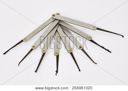 Set of lock picks on white background.