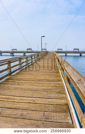 A View Of The Entrance To A Wooden Pier In Ruston, Washington.