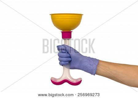 Female Hand In A Purple Rubber Glove Holds A Yellow Plunger With A Pink Plastic Handle. Isolate On W