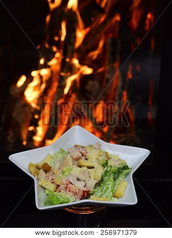 Serving Shicken Salad For Healthy Diet On Burning Flame Background. Balanced And Adequate Diet. The 