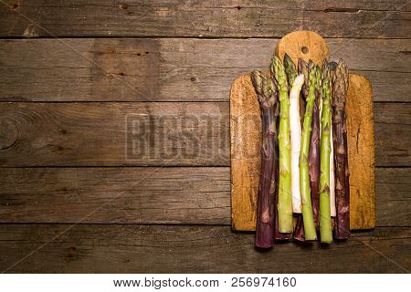 Set Collection Purple Green White Asparagus Flat Lay On Old Wooden Rustic Background. Vegetarian Die