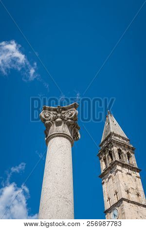 Large Column In Front Of Saint Nikola Church Tower In Perast, Kotor Harbor, Montenegro