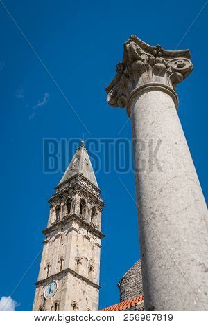 Large Column In Front Of Saint Nikola Church Tower In Perast, Kotor Harbor, Montenegro