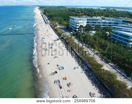 MIELNO, POLAND - 02 SEPTEMBER 2018 - Aerial view on sunny beach with tourists at baltic sea on Mielno city