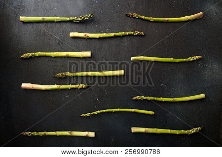 Background Flat Lay Green Asparagus On Black Table.