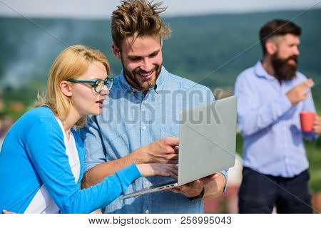 Colleagues Working Laptop, Boss Smoking While Coffee Break On Background. Colleagues With Laptop Wor