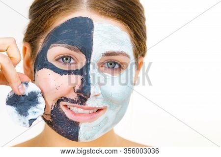 Woman With Clay Carbo Black Mask On One Half Face And White Mud On Second Half. Girl Removing Cosmet