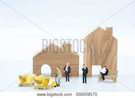 Miniature Business Man With Worker Carry The Gold To Buy Building And Land Isolate On White Backgrou