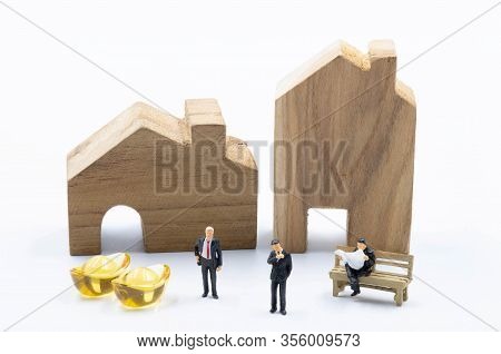 Miniature Business Man With The Gold In Front Of The Building And Land Isolate On White Background I