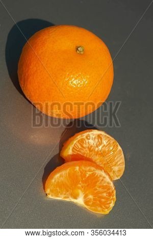 Tangerines With A Slice Isolated On White Background.