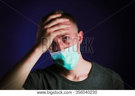 Caucasian Sick Man In A Medical Gause Mask With Palm On His Head. Virus Prevention Concept