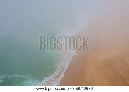 Sea And Sandy Beach In Dense Fog, Autumn Day