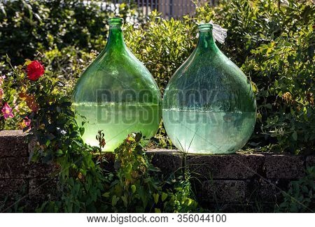 Demijohn Wine Bottles At Vineyard Of The Prosecco Sparkling Wine Region In Valdobbiadene, Italy.