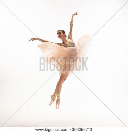 Graceful Classic Ballerina Dancing, Posing Isolated On White Studio Background. Tender Peach Cloth. 
