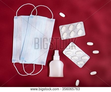 P Revention Of C Oronavirus. Medical Masks, Vitamins, Antiseptic On A Red Background.