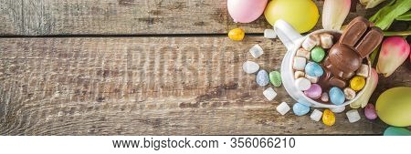 Easter Hot Chocolate With Chocolate Bunny Rabbits. Easter Eggs And Marshmallow, Wooden Background Wi