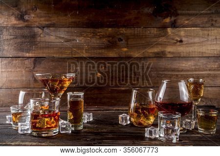Assortment Various Hard And Strong Alcoholic Drinks In Different Glasses: Vodka, Cognac, Tequila, Br