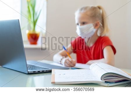 Distance Learning Online Education. Blurred Sickness Schoolgirl In Medical Mask Studying At Home, Lo