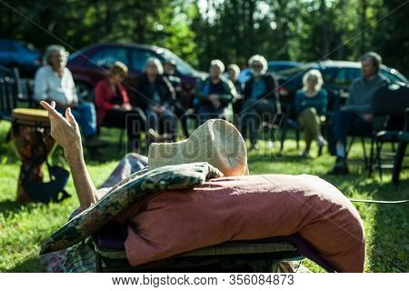 A Close Up Shallow Focus View From Behind A Terminally Ill Frail Man Lying On A Sun Lounger In Garde