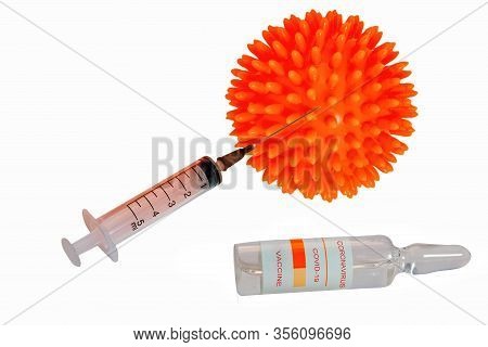 A Syringe And A Glass Ampoule With The Inscription Coronavirus Covid-19 Vaccine On The Background Of
