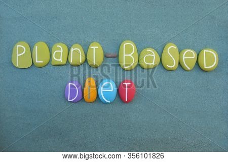 Pland Based Diet Text Composed With Multi Colored Stone Letters Over Green Sand