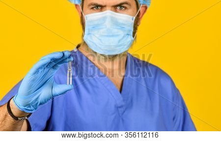 Medical Specialist Hold Test Tube, Selective Focus. Doctor Wear Respirator Mask. Nurse With Coronavi
