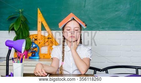 Girl Cute Child Sit School Classroom Chalkboard Background. Progress And Achievements. School Lesson