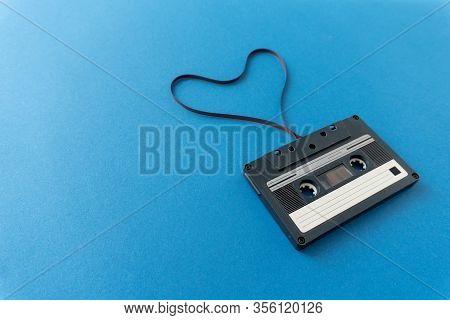 Retro Audio Stereo Mono Black Cassete With Magnetic Tape In Shape Of Heart. Top View At The Cassete 