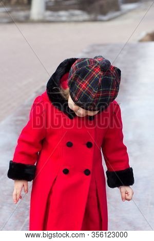 Silhouette Of Little Girl In Red Coat And Beret Looking Down Outside