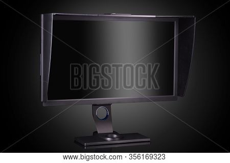 Professional Photographer Monitor With Shading Hood Isolated On Black