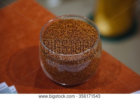 Glass Jar With Millet Grain On Wooden Table