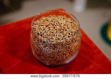 Glass Jar With Wheat Grain On Wooden Table