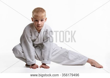 Judoka Boy Doing Stretching At A Workout
