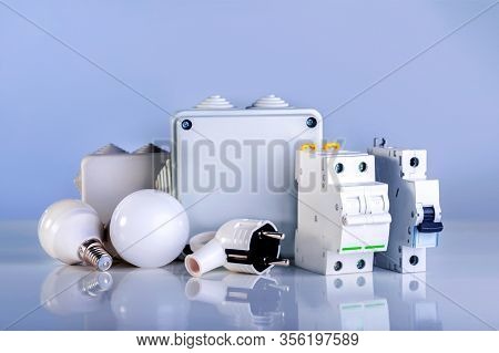 Different Electrical Equipment On Blue Background. Electrical Component For Repair.