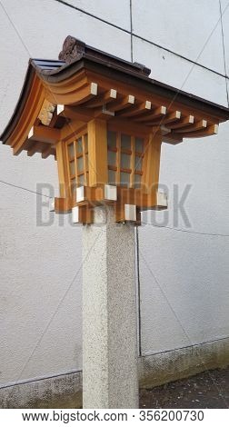 Wooden Birdbox Like Shrine On Concrete Pillar In Tokyo Alley, Japan