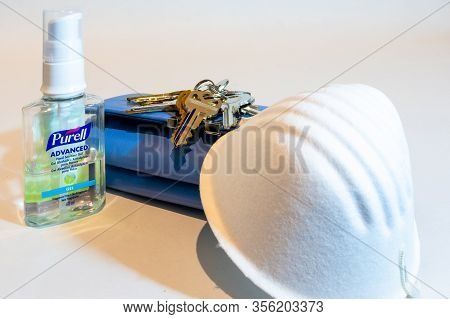 St Elizabeth, Jamaica - March 06 2020: Purell Advanced Hand Sanitizer Gel, Mask, Keys, Purse On Whit